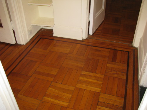 Amazing quarter-sawn oak floors with mahogany inlay to be even more amazing after we have then sanded and refinished.