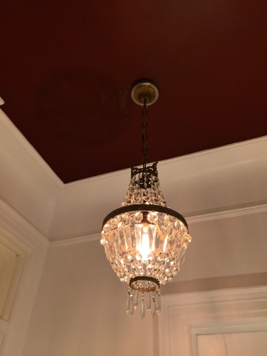 French crystal basket chandelier against red ceiling. So very good....