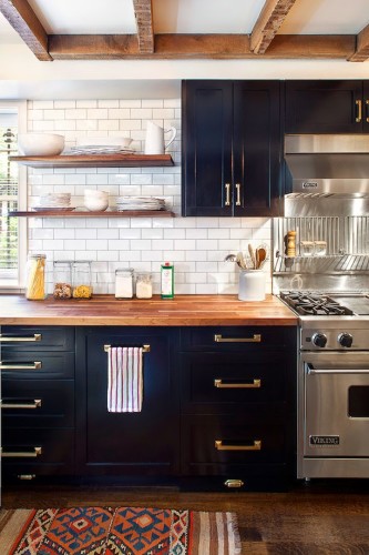 I have never been a fan of brass, but it just looks like it belongs in this kitchen and the overall idea of brass cabinet hardware seems to be the direction we want to head in our kitchen. You can see there is a theme going on here... Black, white, wood, brass... beautiful, although we will not be buying Viking range anytime soon. 