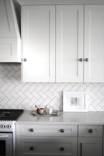 There is too much white going on here, but the herringbone tile on the wall is absolutely amazing... This can be done with inexpensive 3x6 inch white subway tile you can pick up for a quarter a piece at the big box store (if you don't mind glossy tiles).