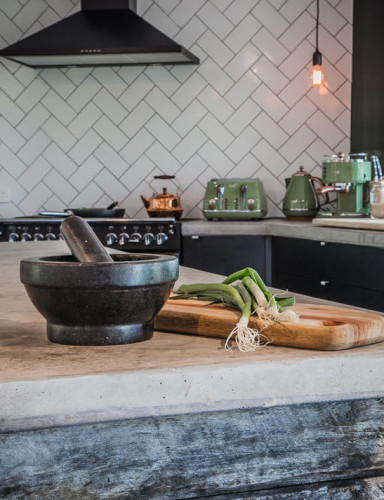 Inexpensive subway tile laid in a herringbone pattern is a great way to elevate a common material to a higher level while keeping it timeless and simple. [Image: Adrian Ramsay Design via Houzz]