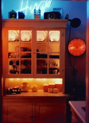 My Seattle kitchen in 1996, mini white Christmas lights strung inside vintage 1905 glass doored hutch. (I still have that vintage 1950s Nehi Clock, and hope to put it to good use in our new kitchen)