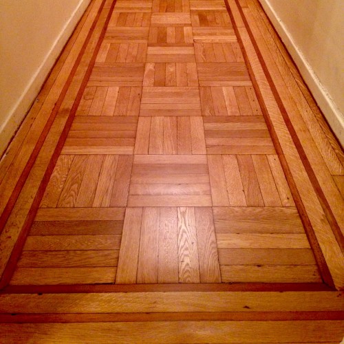 This is the entry gallery floor in September of 2014 the day after we had them refinished. This oak with mahogany bordered floor is still throughout our apartment except for the bathroom and now the kitchen.