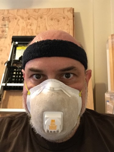Yours truly sporting my dirty filthy dust mask after digging through cinders for three hours. Glad that brown stuff isn't in my lungs.
